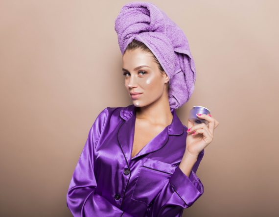 young-girl-in-purple-pajamas-and-turban-with-cream-3JPEYNU